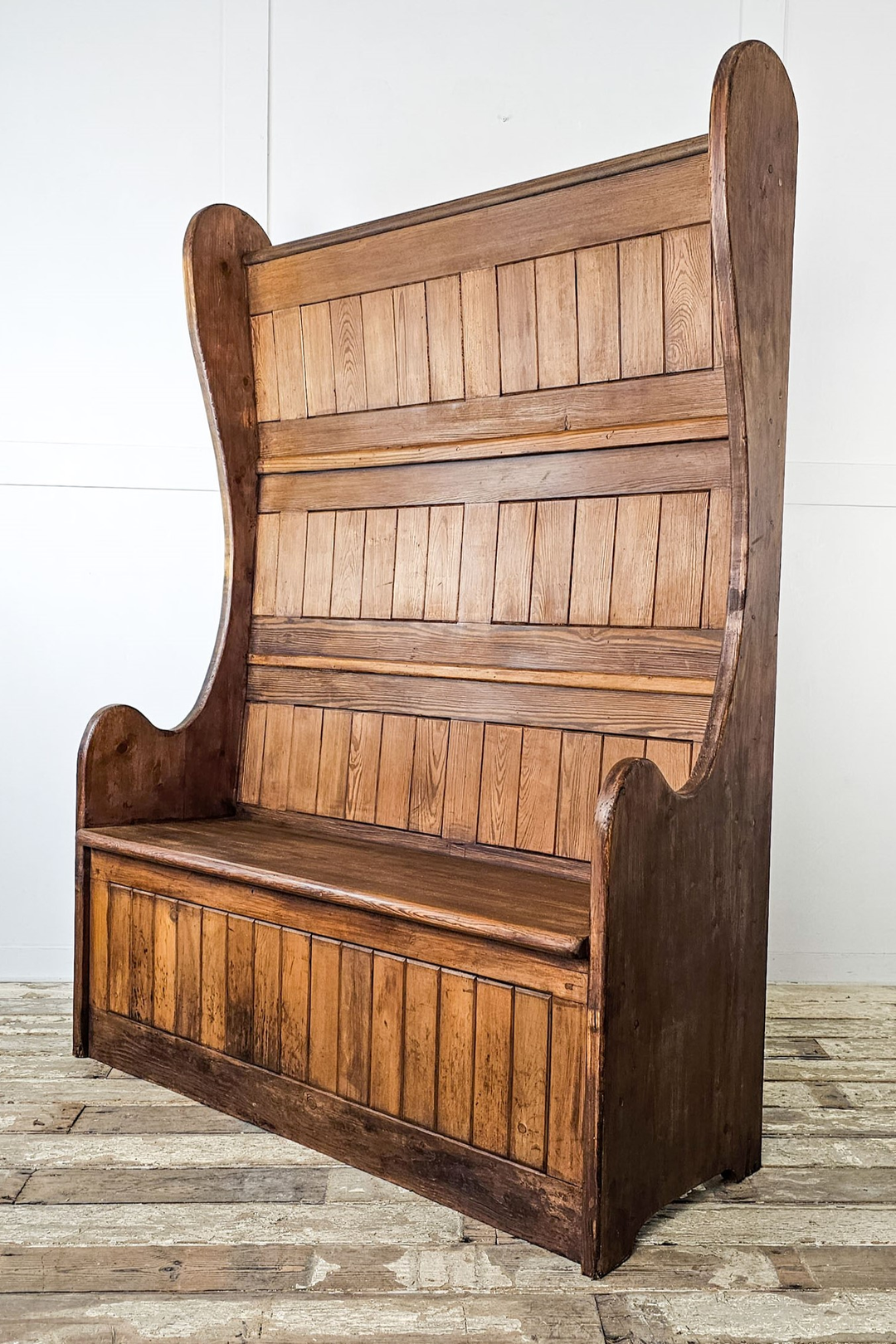 An early 20th Century french station bench with seating on both sides - angled view