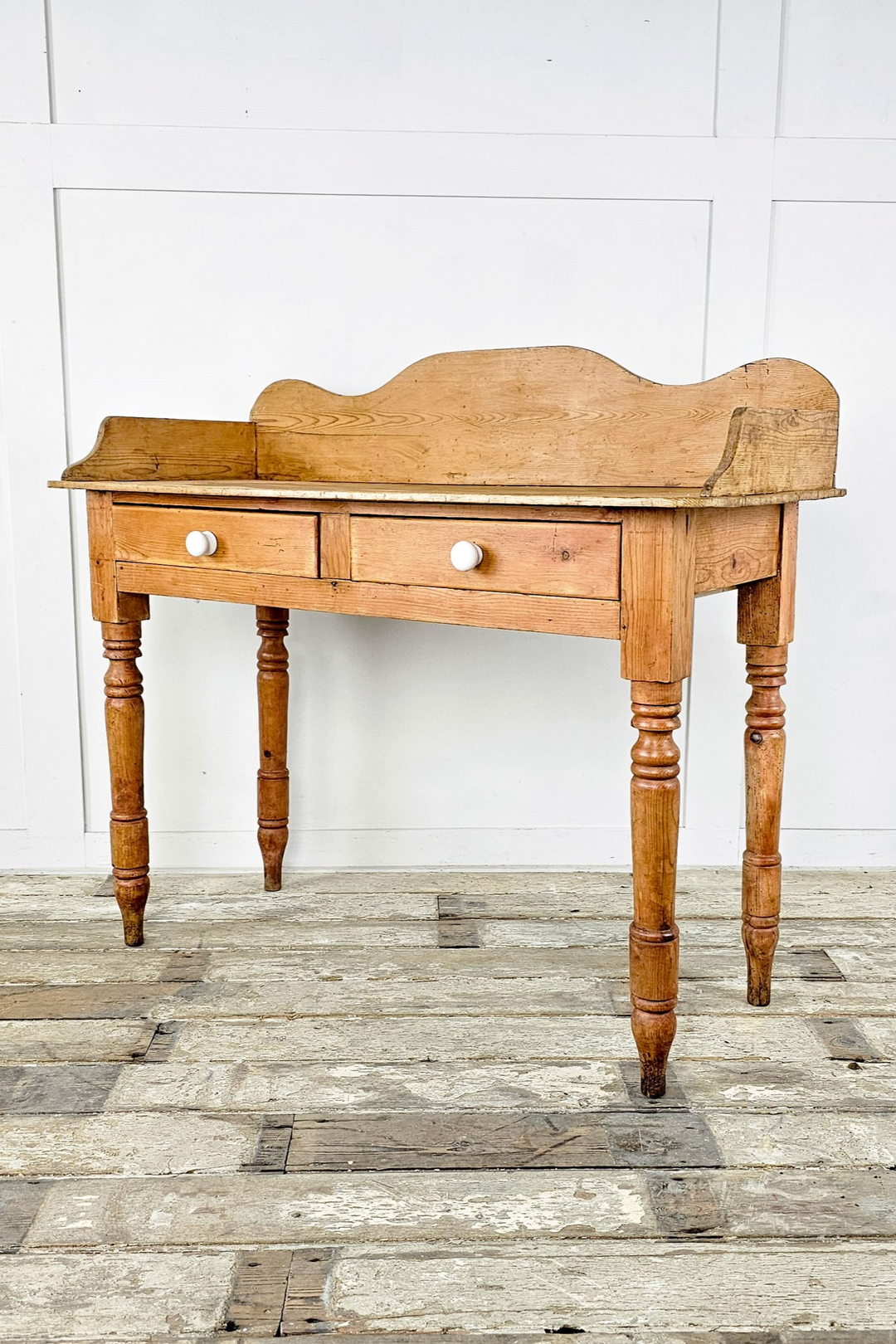  A Victorian pine desk with three drawers for storage - Angled View