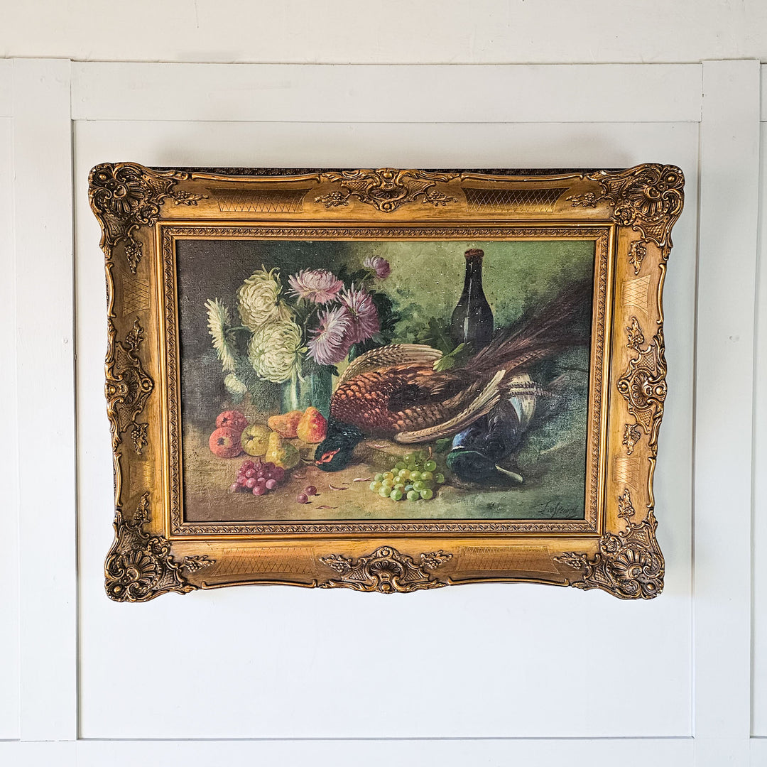 Classic French still life artwork with an array of fruits and game birds, beautifully captured in oil paint, complete with a lavish gilded frame