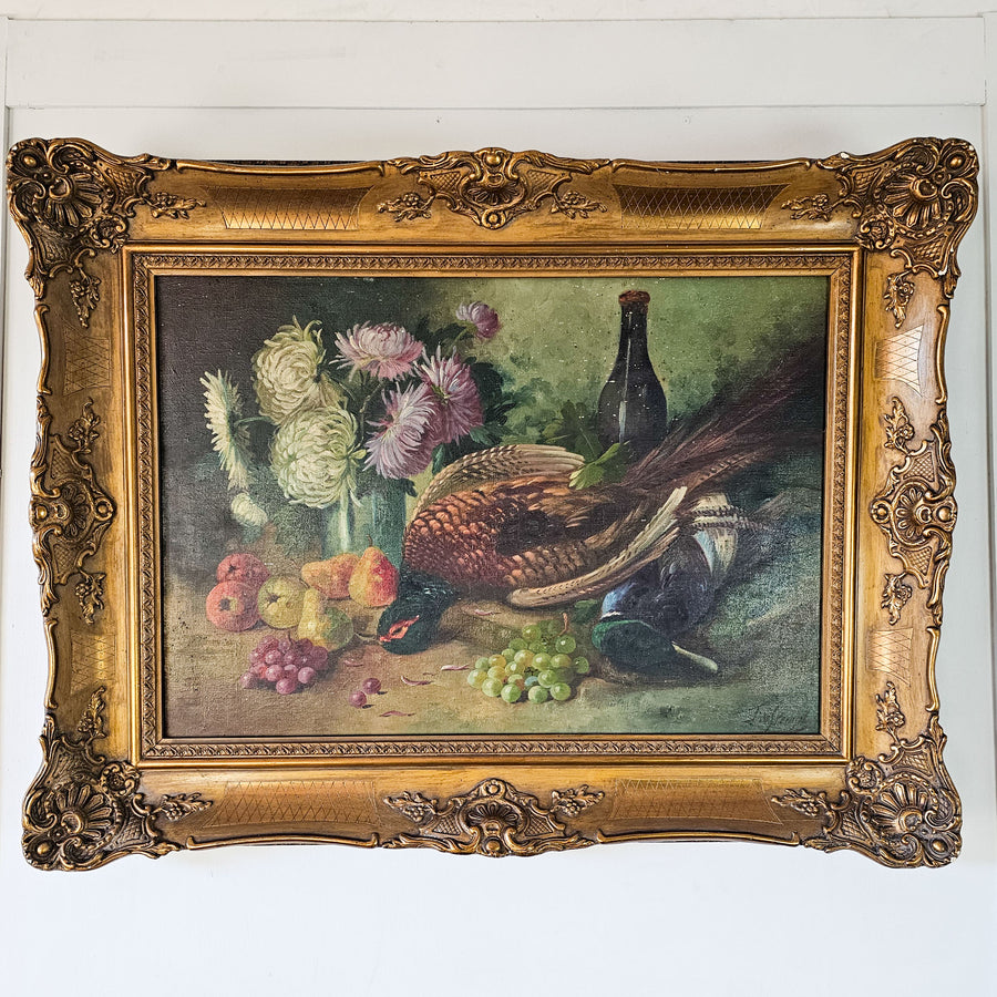Antique French still life canvas showcasing detailed dead game with fruit, set in an elaborate gold frame, signed by artist.