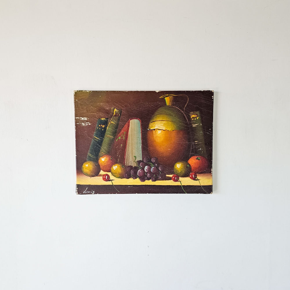 Vintage French oil painting on canvas showcasing a quaint array of fruits and books, with a signature in the lower left corner.