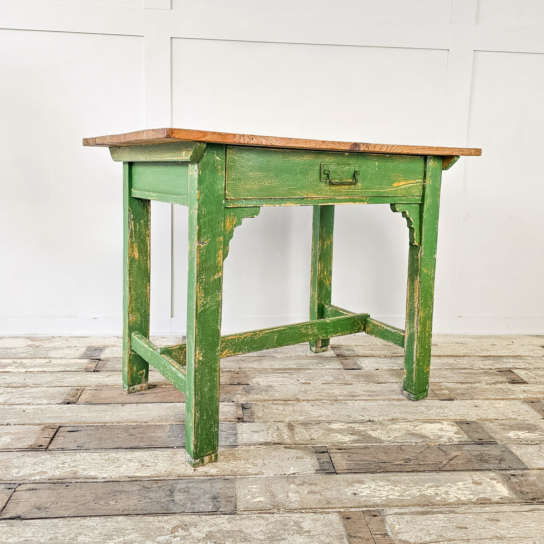 A small antique pine prep table from the early 20th century with singular drawer and waxed pine top - Angled View