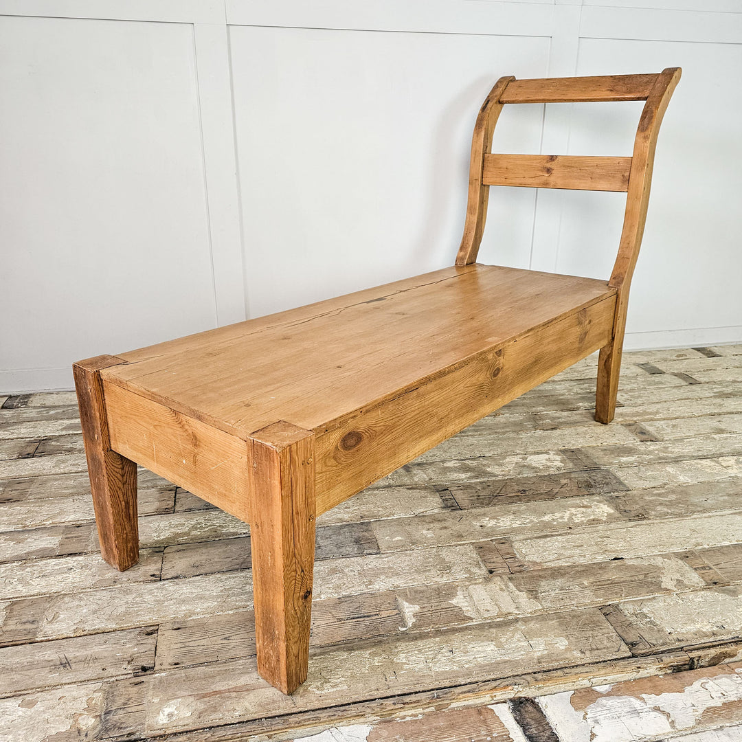 Antique pine bench with four straight legs, versatile for seating or lounging