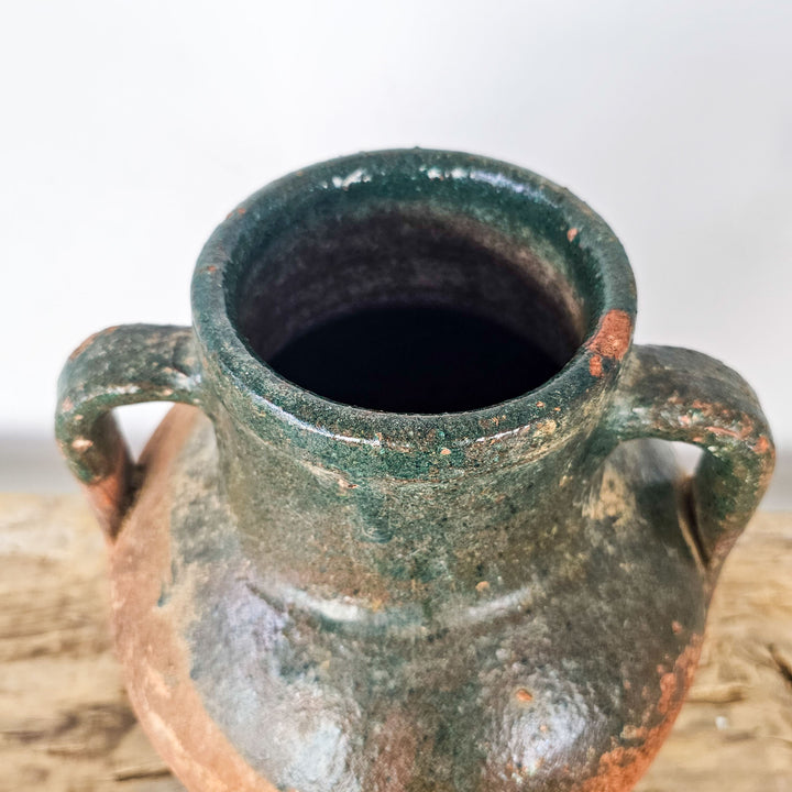 Vintage earthenware pot with green glazed rim and carrying handles, perfect for home decor or displaying faux flowers.