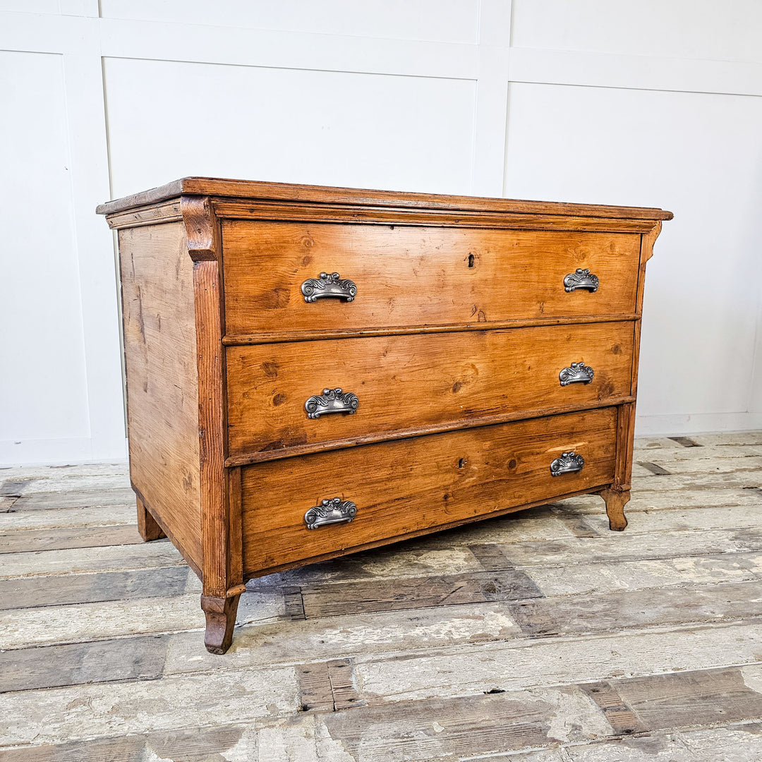 Angled view of an antique pine mule chest showing the warm, waxed pine patina
