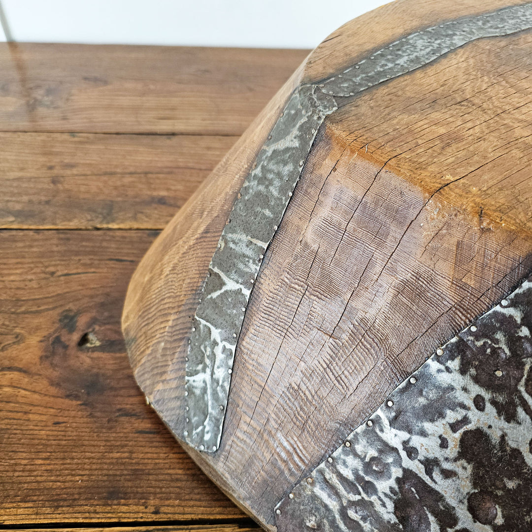 Rustic wooden bowl with historical significance and charm.