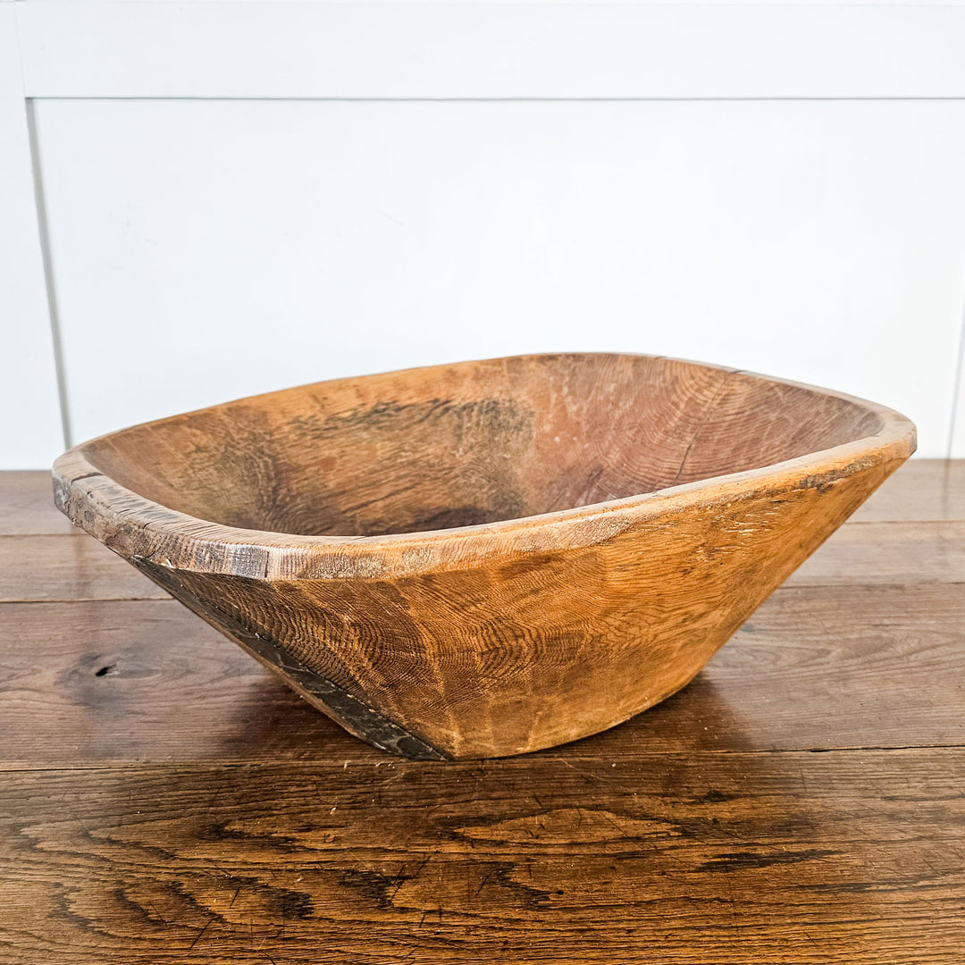 Vintage dough bowl with carved handle for easy handling.
