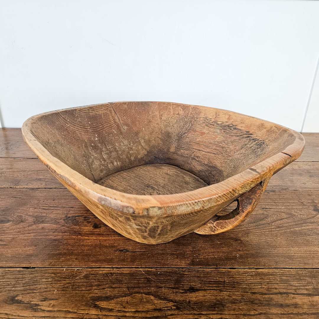 Decorative dough bowl with rustic charm and time-worn aesthetic."
