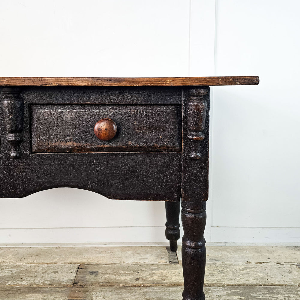 Antique pine console with original black paint and two drawers.