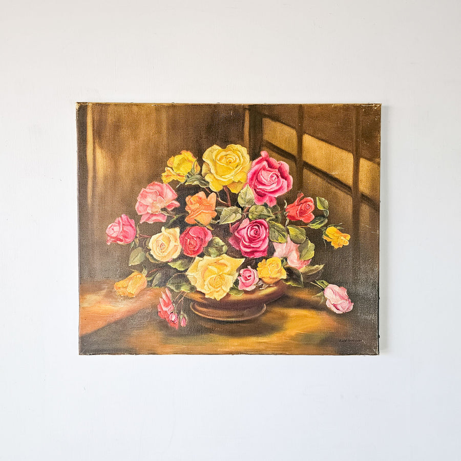 Vintage oil painting on canvas depicting a vibrant bouquet of roses in yellow, pink, and red hues, elegantly arranged in a bowl on a table, with a warm, illuminated background.
