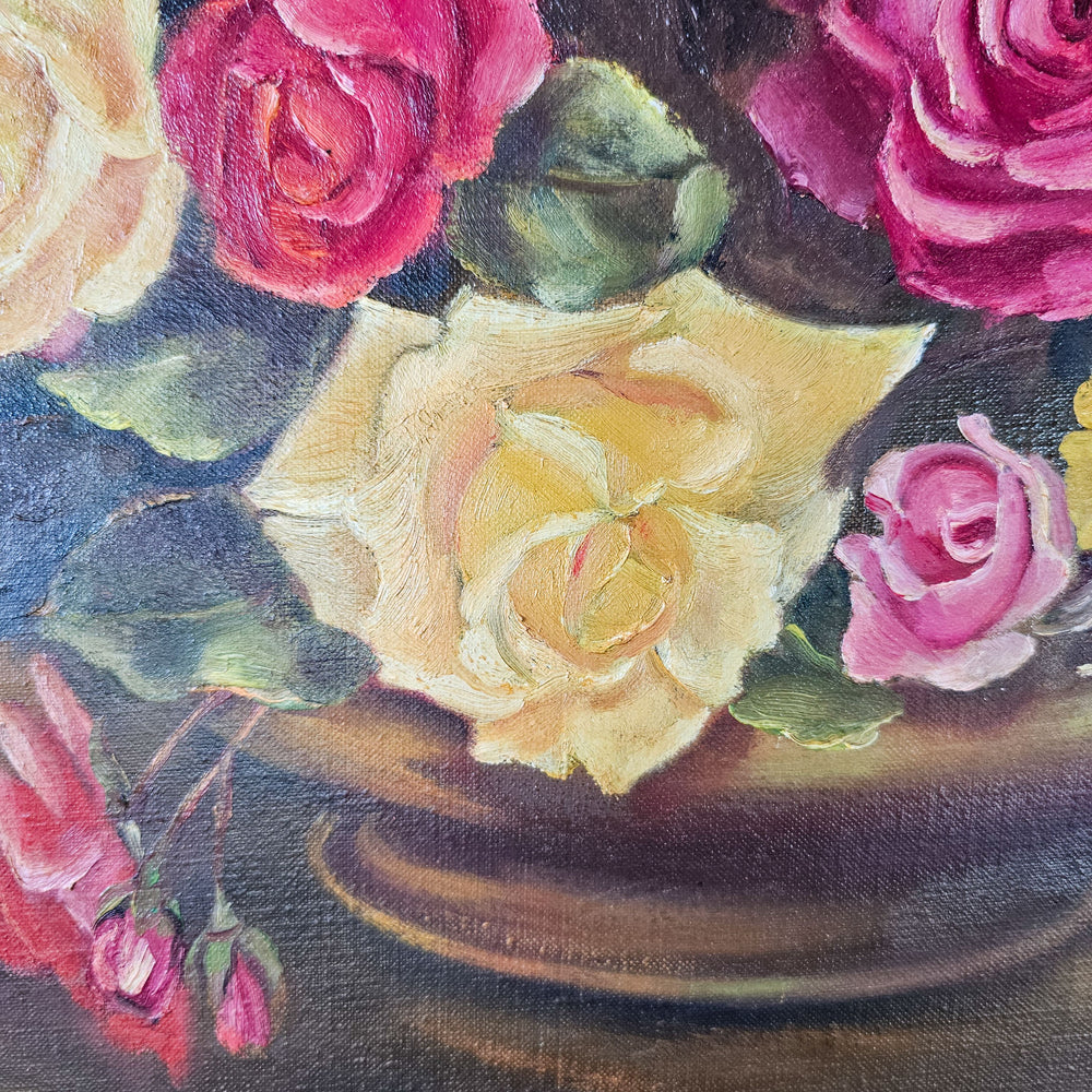 Close-up detail of a vintage oil painting showing thick, textured brushstrokes on petals of roses in shades of yellow and pink, highlighting the artist’s skillful use of color and light.
