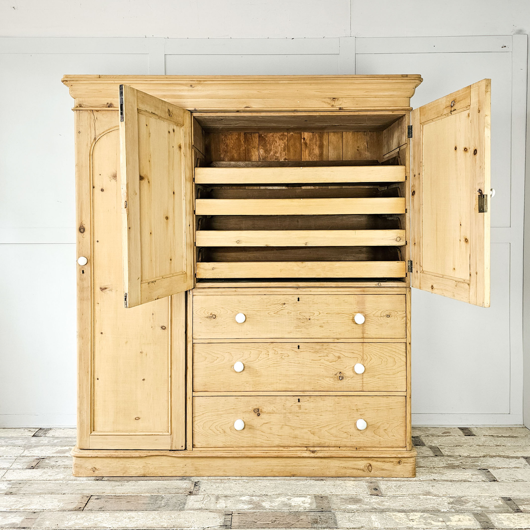 A small pine chest of drawers, with three drawers in the Aesthetic Movement style with straight and angular lines - angled view