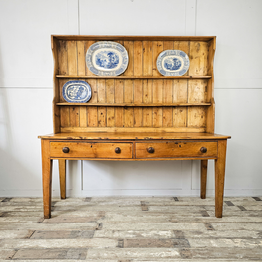 A small pine chest of drawers, with three drawers in the Aesthetic Movement style with straight and angular lines - angled view