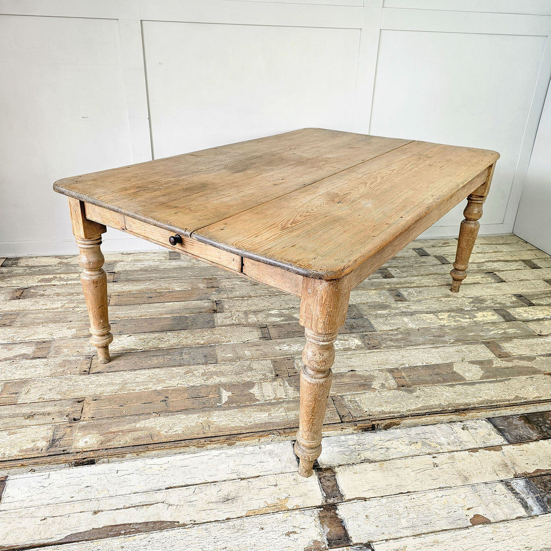 A large Victorian pine kitchen table - front angled view showing wide top.