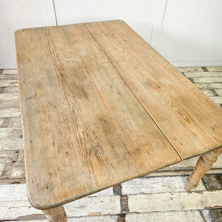 Rustic dining table with four turned legs and drawers, top view