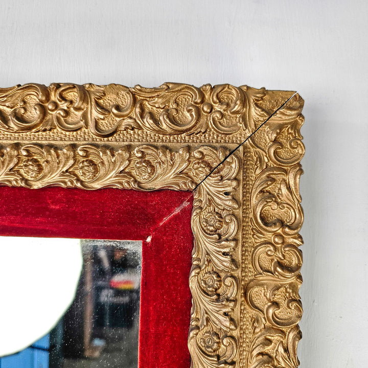 Close-up of the mirror's frame corner, highlighting the delicate craftsmanship with intricate gilded details, a testament to its Victorian charm."