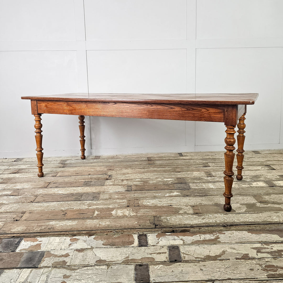 19th century French farmhouse table with smooth planked top and traditional shaped legs
