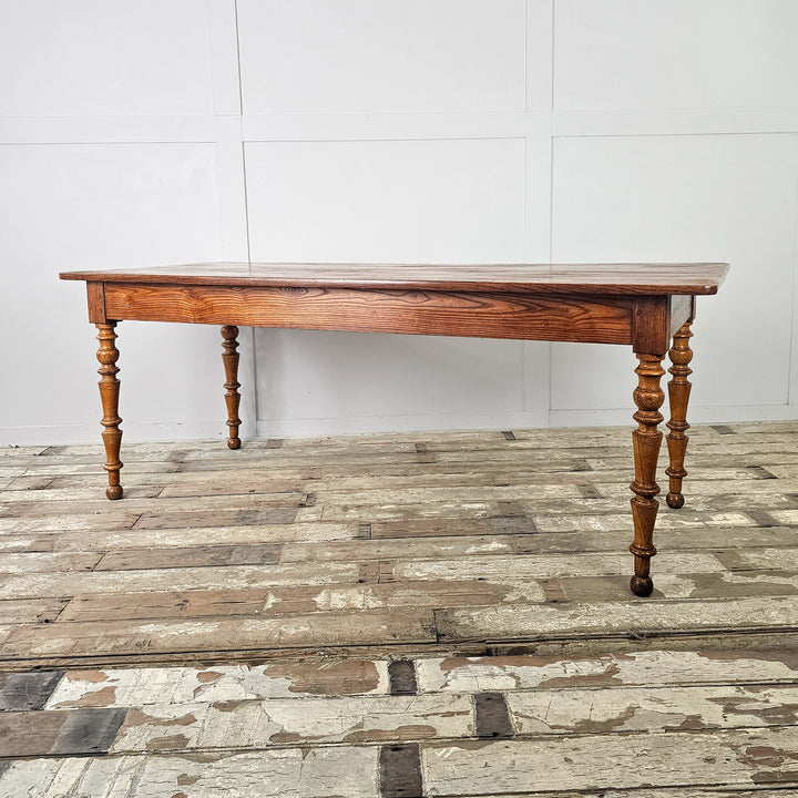 19th century French farmhouse table with smooth planked top and traditional shaped legs
