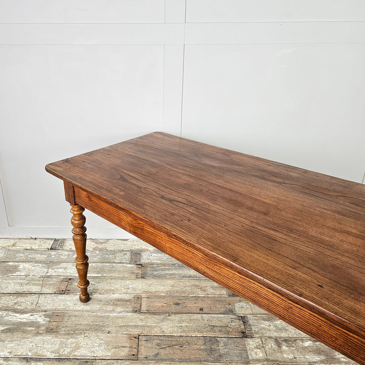 Antique elm and fruitwood dining table with planked top and shaped legs, ideal for kitchen or dining room use