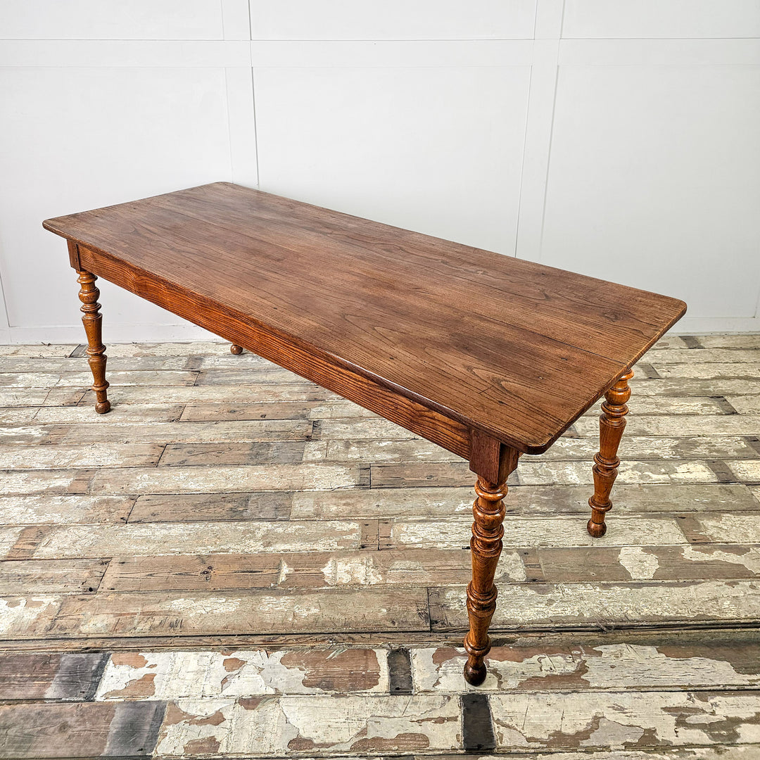 French farmhouse dining table in solid elm with fruitwood legs and space to seat up to eight
