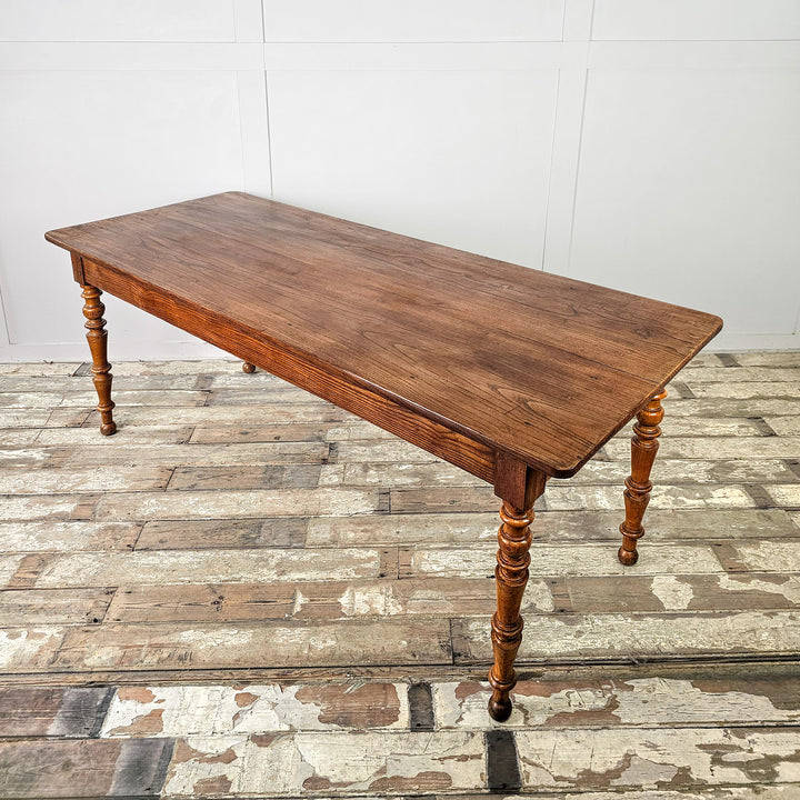 French farmhouse dining table in solid elm with fruitwood legs and space to seat up to eight
