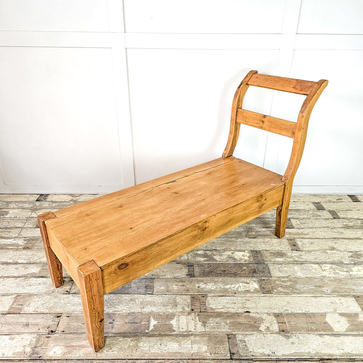 Early 20th-century French pine bench with sleigh-style ends.
