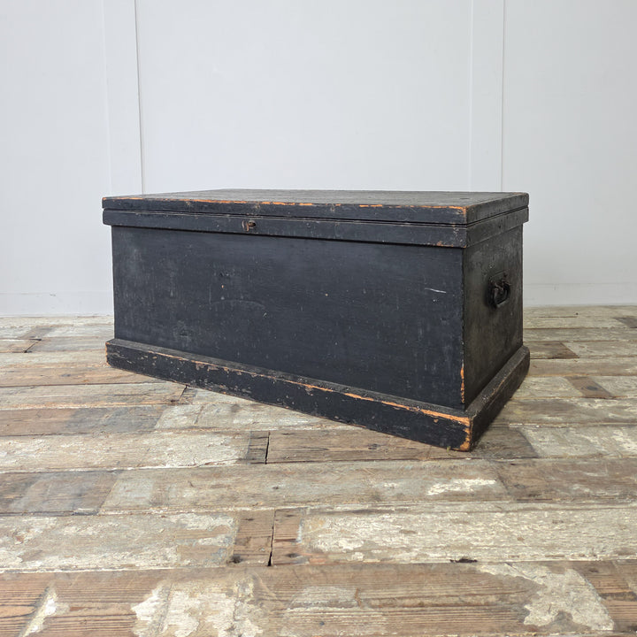 A Victorian painted pine blanket chest with bold black finish and practical interior storage space.
