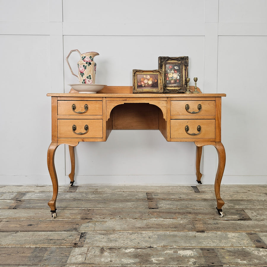 Antique pine desk with cabriole legs and four drawers
