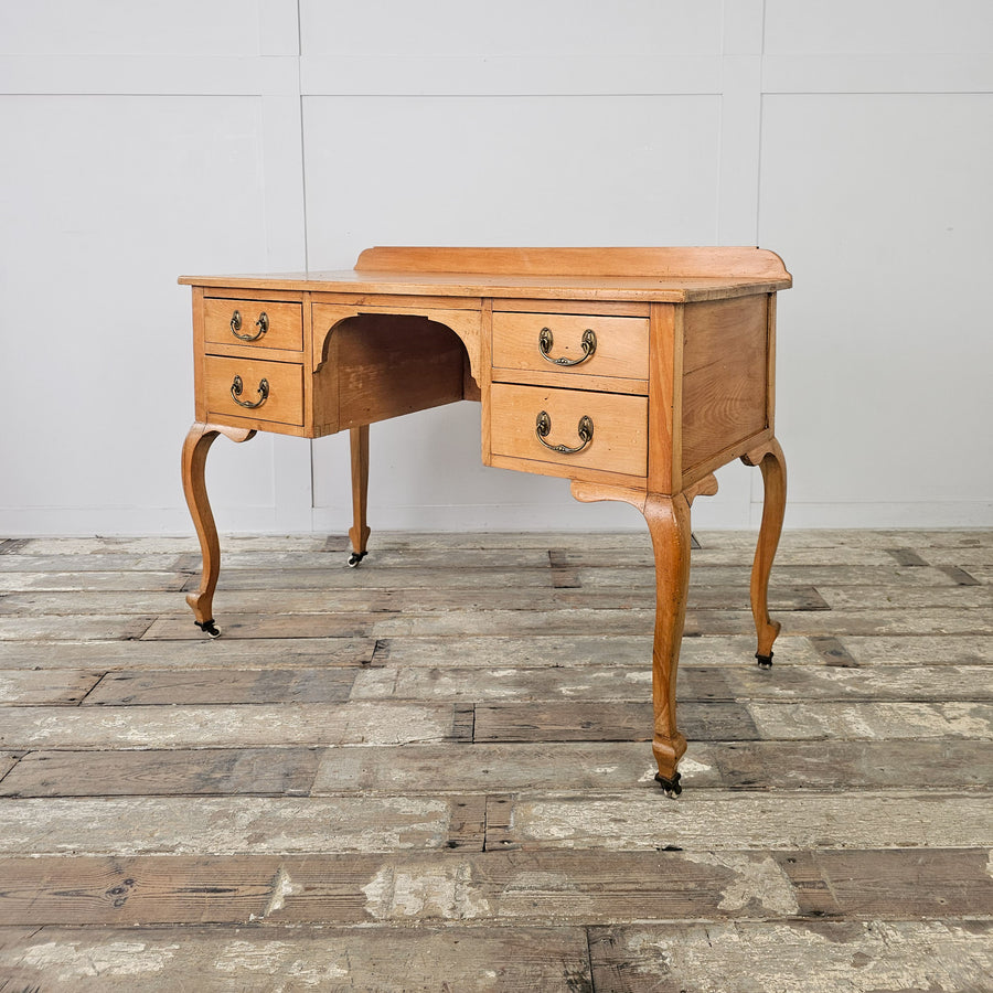 Antique pine desk with cabriole legs and four drawers
