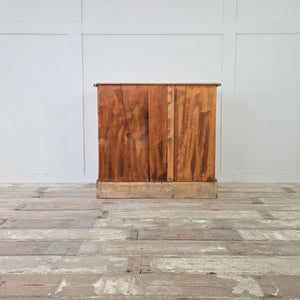 A simple early 20th century antique pine chest with three drawers of varying depth, finished in honey pine tones with original swing handles and plinth base, a functional farmhouse furniture piece ideal as rustic bedroom drawers, a country storage chest, or hallway storage furniture.