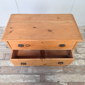 Antique pine storage chest in early 20th century design with three drawers, graduating in size, each with original swing handles, finished with a honey pine patina, ideal for farmhouse interiors, cottage bedrooms, or as a practical pine chest of drawers for rustic storage solutions.