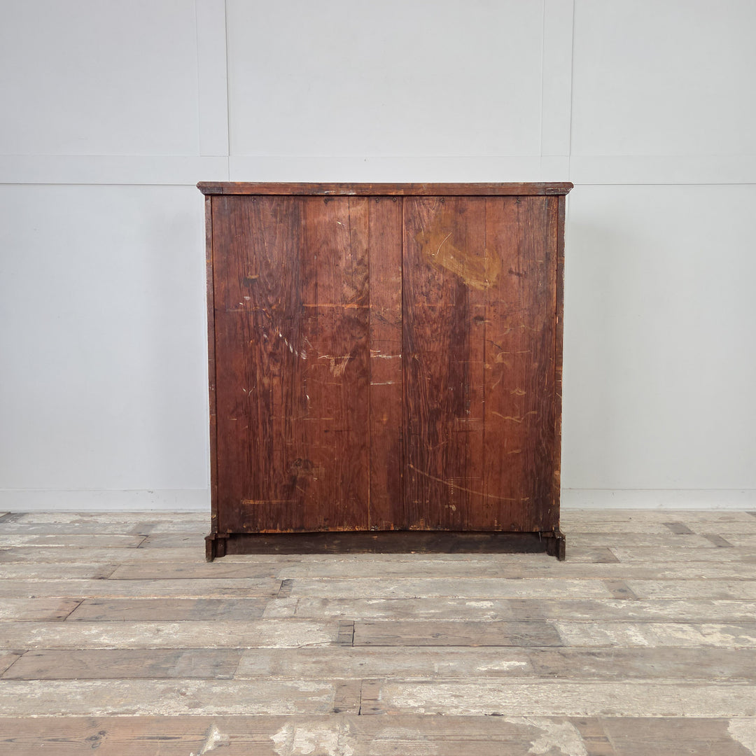 Golden-toned ash chest of drawers, late 19th century, with reeded drawer fronts, brass drop handles, and two short over three long graduated drawers.