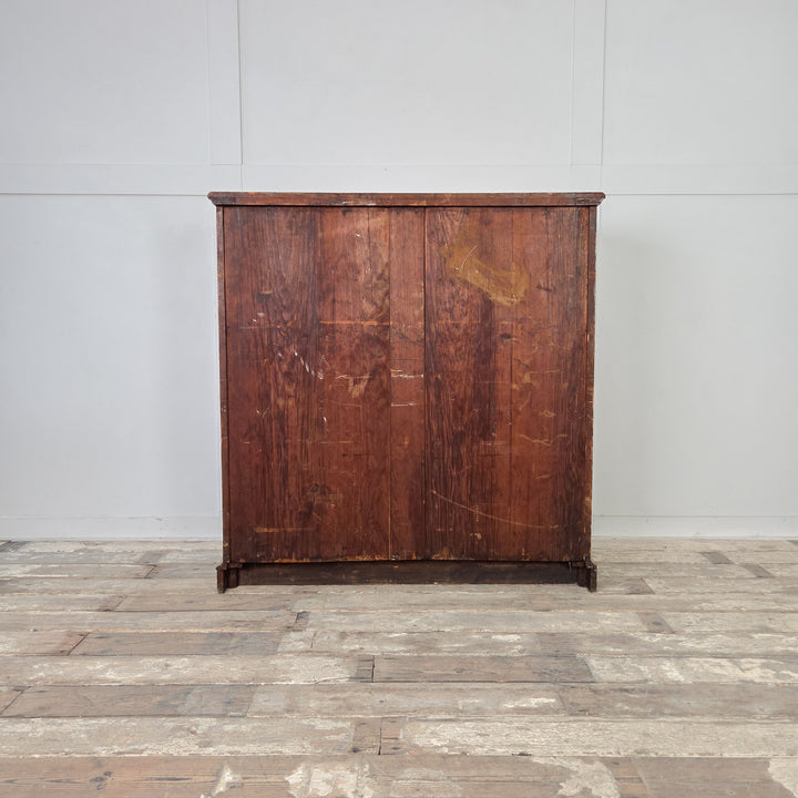 Golden-toned ash chest of drawers, late 19th century, with reeded drawer fronts, brass drop handles, and two short over three long graduated drawers.