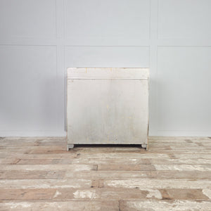 Antique ash chest of drawers from the early 20th century, with three drawers increasing in depth and a decorative gallery back along the rear edge.
