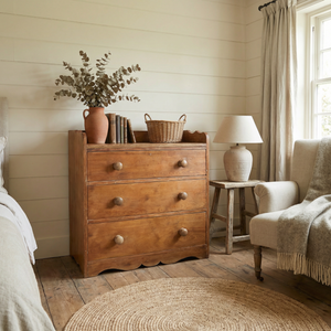 Antique ash chest of drawers dating from the early 20th century, with three deep drawers that graduate in depth, a gallery-style back to the top, and a decorative shaped plinth base.
