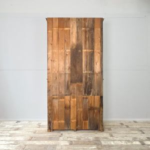 A substantial antique pine bank of drawers featuring 34 drawers arranged across the upper section, each with brass label holders and decorative pulls. The lower cupboard includes two fixed shelves, offering flexible storage. Finished in clear wax, this piece reflects a strong country and farmhouse-style construction.