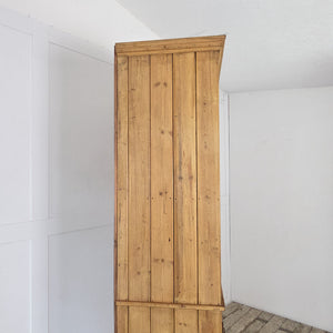An antique pine storage bank fitted with 34 drawers, each with brass label holders and pull handles. Beneath sits a two-door cupboard with fixed shelves. Finished in clear wax, this farmhouse-style pine storage cupboard offers organised space for both smaller items and larger household needs.