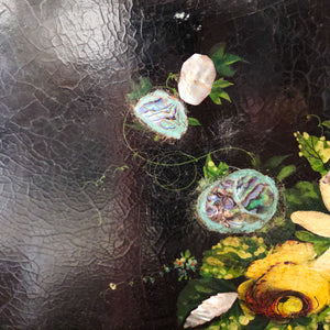An antique Victorian papier-mâché tray from the mid to late 19th century, featuring a black lacquered surface, scalloped ogee edge, painted decorative details, and a floral centre finished with mother of pearl inlay. A versatile decorative piece that can be displayed on a table, stand, or used as wall décor.