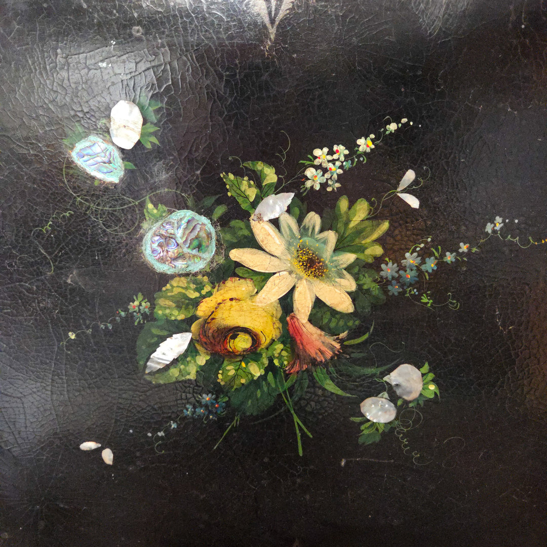 An antique papier-mâché tray from the 19th century with colourful painted florals and iridescent inlay, scalloped edging and scrolling foliage, perfect for display on a sideboard or as a hanging wall tray in a sitting room.