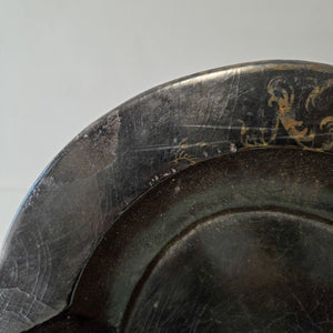 This mid to late 19th century Victorian papier-mâché tray features a black lacquered finish with painted and gilt decorative details, scalloped edges, and a handpainted floral bouquet with mother of pearl inlay to the centre. Originally made for serving tea or drinks, it now lends itself well to decorative display.