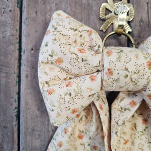Padded bow with peach and green floral pattern
