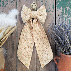 Handmade padded fabric bow in small floral print
