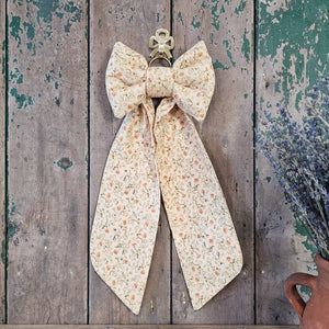 Fabric bow with long tapering tails
