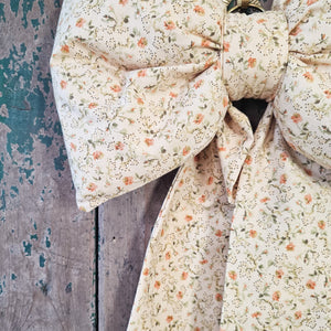 Padded decorative bow with ditsy floral design

