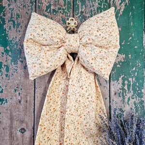 Upholstered fabric bow with delicate print
