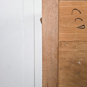 A rustic early 19th-century pine and ash chest of drawers with panelled sides, shaped bracket feet and four drawers fitted with round knobs and original ivory escutcheons. A useful storage chest for clothing or household items.