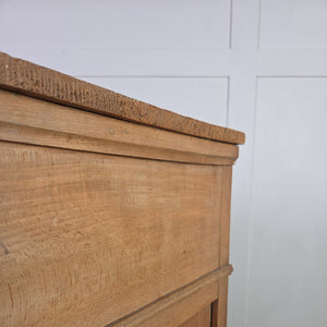 An early 19th-century farmhouse style chest of drawers built in pine and ash with original ivory escutcheons. Two short drawers sit above two long, and the piece stands on shaped bracket feet with neatly panelled sides.
