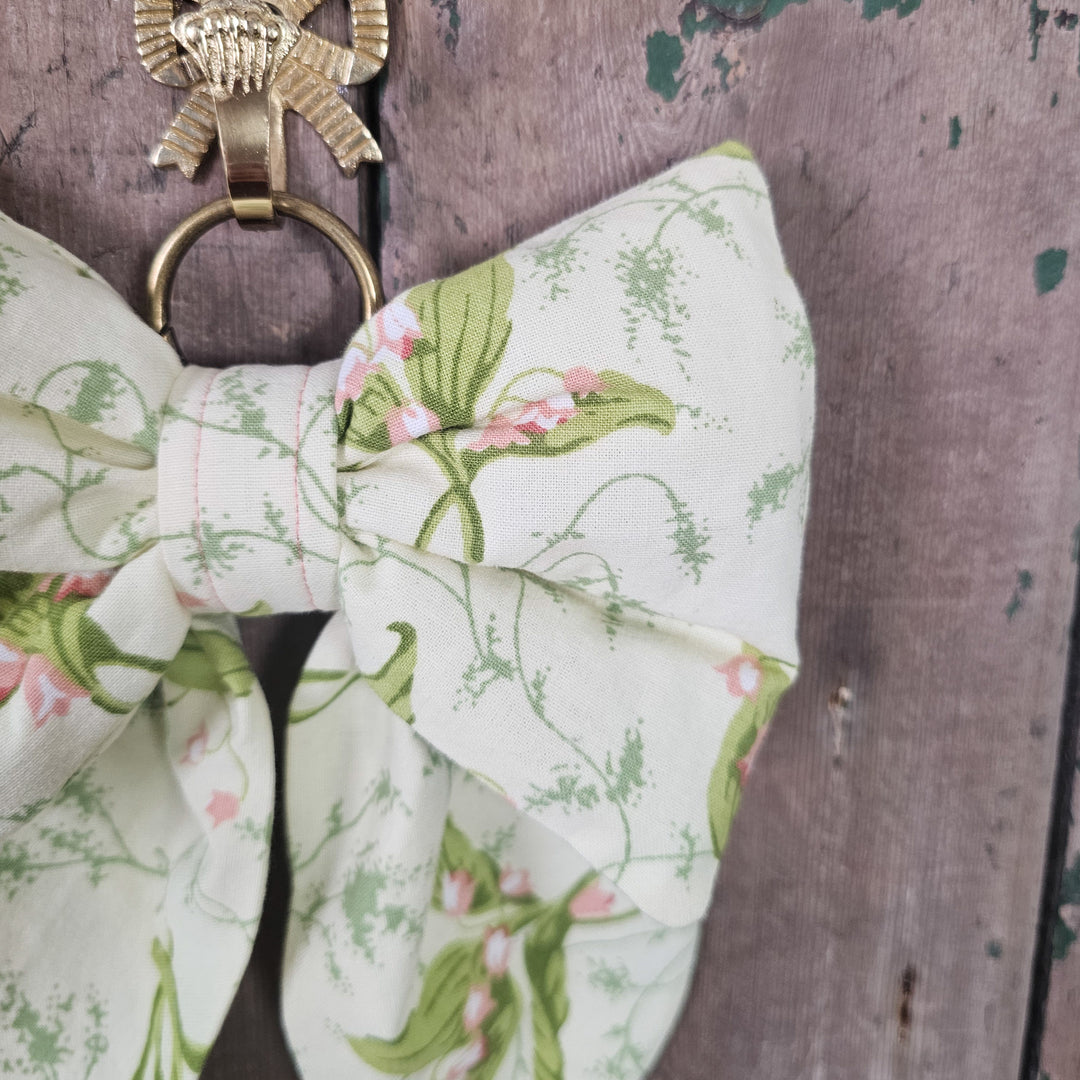 Handmade fabric bow with soft pink flower detail