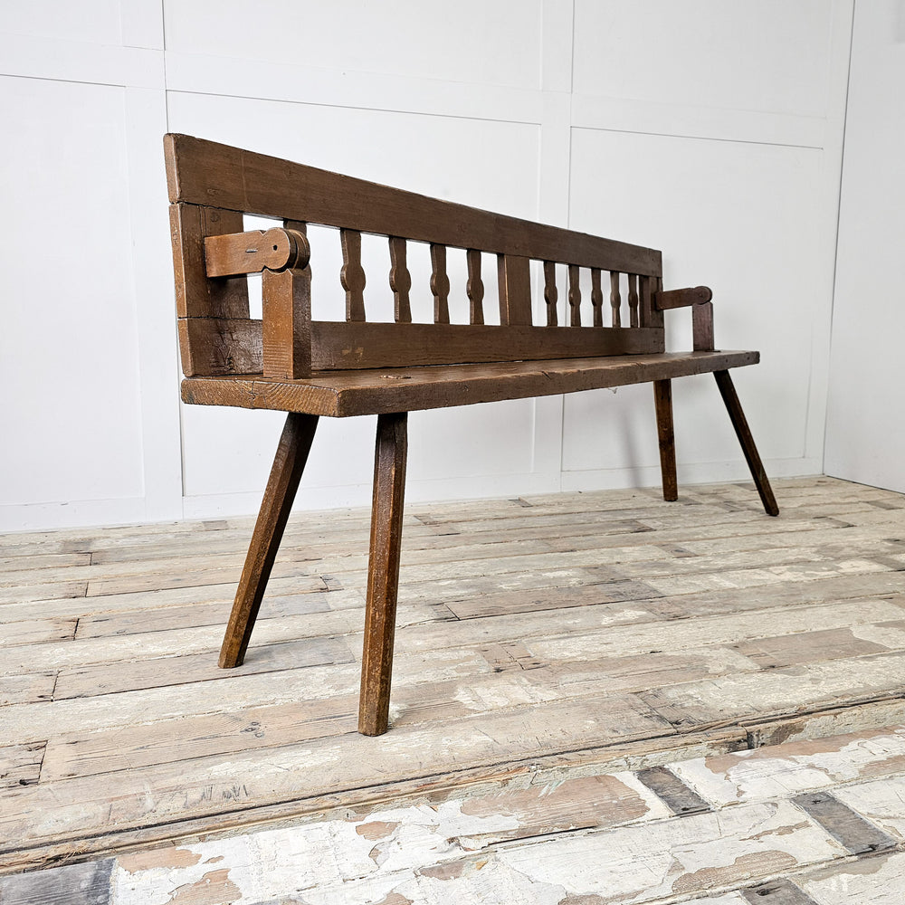Primitive church bench with splayed legs