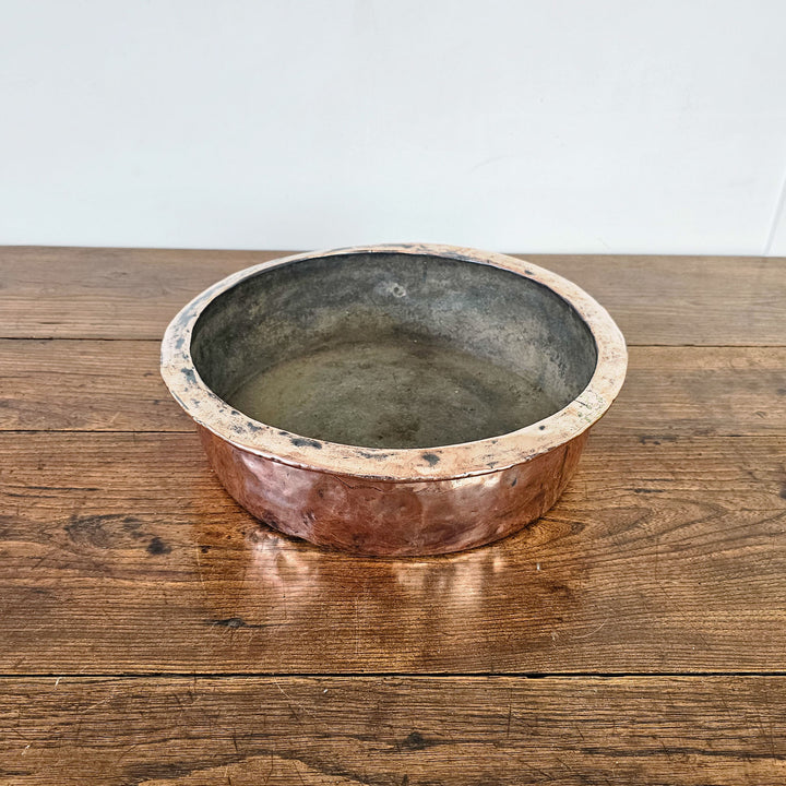 Shallow antique copper bowl with original patination.